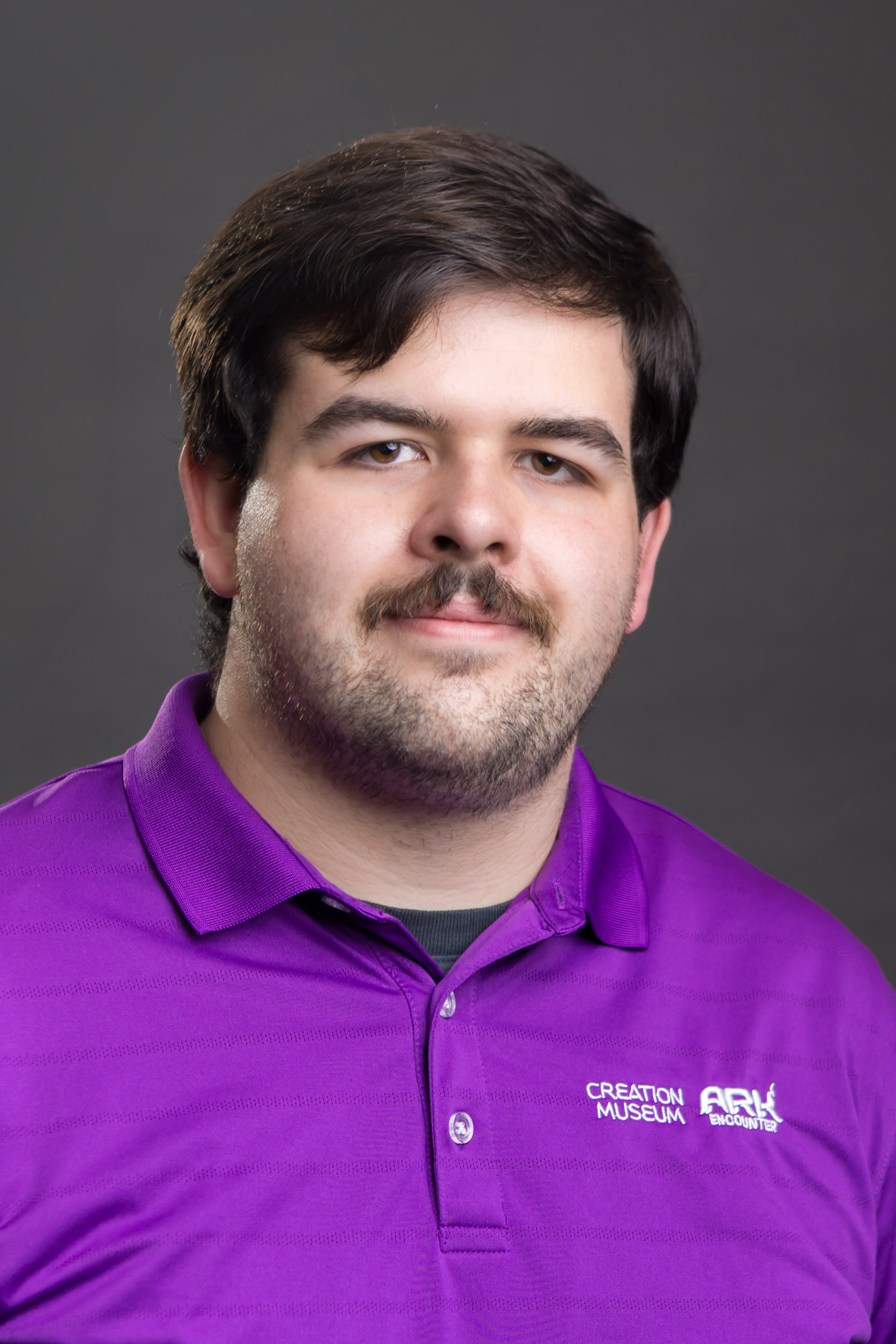 Business headshot of a professional man on a dark background